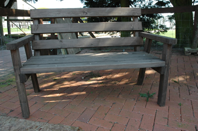 A wooden 2 seat park bench